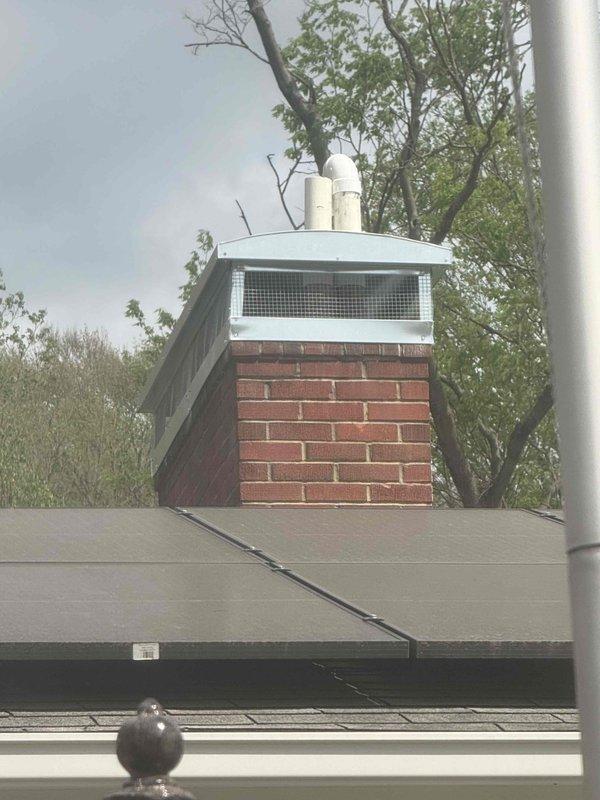Installed metal chimney cap with mesh screening on brick chimney structure to prevent animal and debris intrusion while maintaining proper ventilation. Inspected heat pump and furnace system for reported leak concerns and documented equipment condition. All work completed per manufacturer specifications with system operational upon departure.