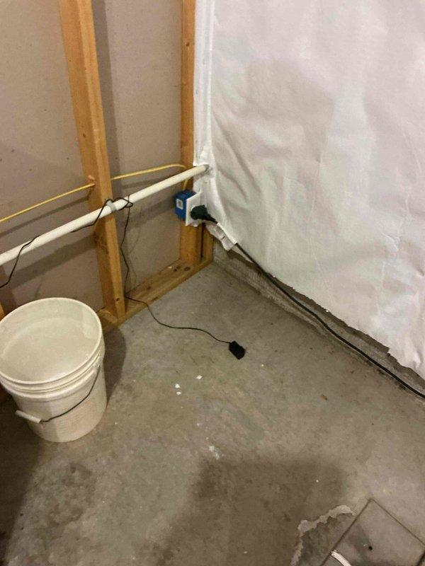 Responded to warranty call for water softener with salt bridging issue on unit installed less than one year prior. Inspected system and confirmed proper operation of replacement water softener unit. Control panel displaying normal parameters with digital display functioning correctly. Verified plumbing connections secure with no leaks present at inlet/outlet PVC piping. Unit positioned properly on base platform with adequate clearance for service access and maintenance.