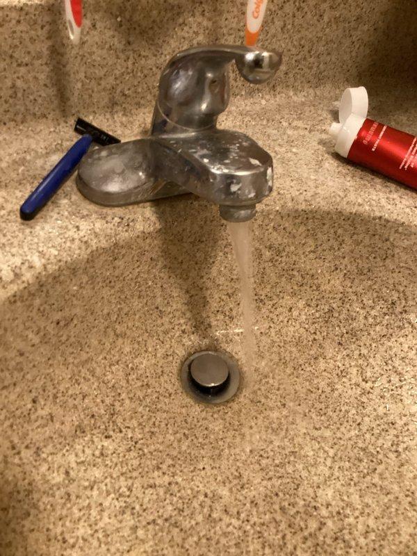 Completed monthly plumbing inspection as part of prepaid maintenance membership. Inspected exterior hose bib and connection point on home's exterior siding, confirming proper operation and no visible leaks at fixture or attachment point. Evaluated interior bathroom faucet operation and water flow, noting minor mineral deposits and hard water buildup on chrome fixture surfaces that do not currently affect functionality.