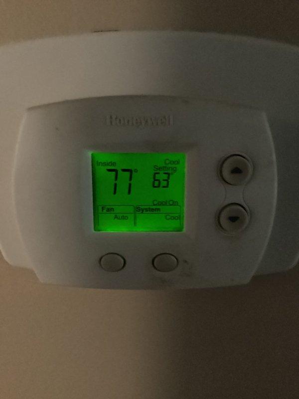 Responded to cooling complaint where system was unable to maintain setpoint of 63-65°F with indoor temperature rising to 72°F and above. Upon arrival, verified thermostat was set to cooling mode with fan on auto, displaying indoor temperature of 77°F with cooling setpoint of 67°F. Inspected HVAC equipment including furnace with air handler and associated components in utility area. System evaluated for proper operation and temperature differential.