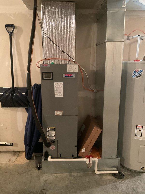 Conducted comprehensive site evaluation for complete heat pump system replacement at 2-bedroom residential townhouse. Assessed existing outdoor condensing unit mounted on concrete pad with proper clearance from building exterior, electrical disconnect, and conduit installation. Evaluated basement-mounted air handler unit with PVC condensate drainage, ductwork with reflective insulation, and adjacent water heater for spatial planning and compatibility considerations. Documented current equipment specifications, installation configuration, electrical connections, and mechanical room layout to provide accurate replacement system sizing and installation proposal for dual heating and cooling capacity heat pump system.