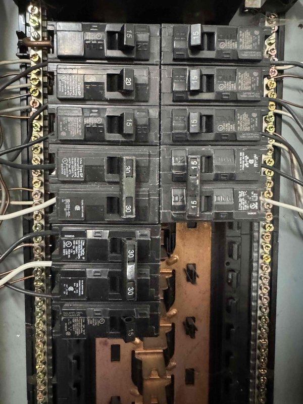 Performed site assessment for electrical installation in workshop loft area requiring ceiling fan installation and 220V receptacle for air compressor located approximately 30 feet from fan location. Inspected existing electrical panel and identified three existing circuits from previous furnace installation that require conductor removal and reconfiguration. Documented attic space access, existing wire routing through floor joists, and current panel capacity to determine scope of work. Coordination with existing installer required to review current outlet configuration and verify electrical requirements for proposed installations before proceeding with two-person installation.