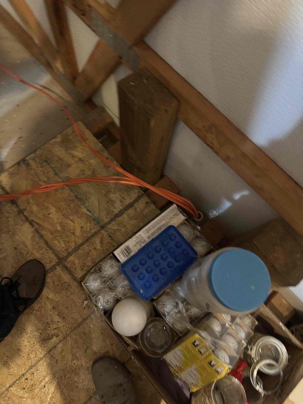 Performed site assessment for electrical installation in workshop loft area requiring ceiling fan installation and 220V receptacle for air compressor located approximately 30 feet from fan location. Inspected existing electrical panel and identified three existing circuits from previous furnace installation that require conductor removal and reconfiguration. Documented attic space access, existing wire routing through floor joists, and current panel capacity to determine scope of work. Coordination with existing installer required to review current outlet configuration and verify electrical requirements for proposed installations before proceeding with two-person installation.