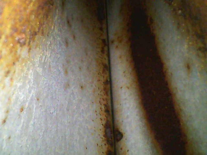 Responded to no-cooling call for residential air conditioning system. Upon arrival, confirmed outdoor condensing unit was not operating while indoor air handler and blower motor functioned normally. Conducted visual inspection of outdoor unit and discovered extensive rust corrosion on refrigerant line set and condensing unit cabinet panels, indicating prolonged moisture exposure and potential refrigerant leak points. Documented deteriorated condition of copper refrigerant lines showing significant oxidation and corrosion patterns. Advised homeowner of equipment condition and recommended comprehensive system evaluation to determine extent of refrigerant line damage and assess condenser unit integrity before proceeding with repairs.