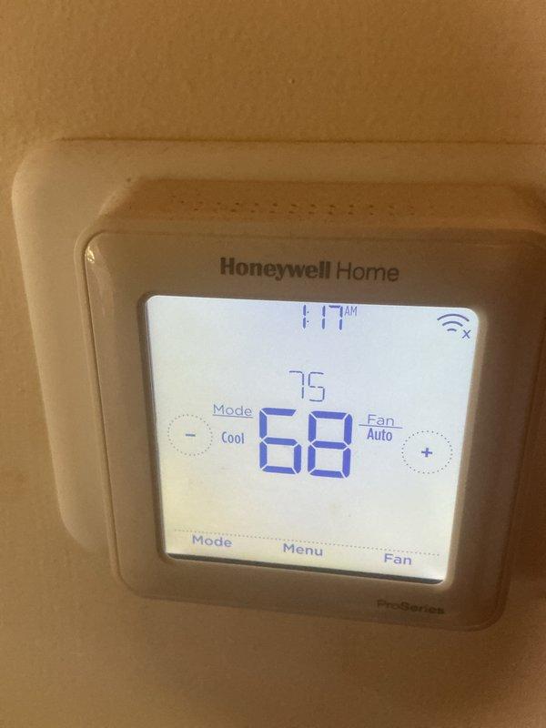 Completed basic monthly heating maintenance on Amana heat pump system. Performed standard inspection of outdoor unit located beneath deck structure, verified refrigerant lines and connections, and checked Honeywell programmable thermostat operation inside residence. System operating within normal parameters at time of service.