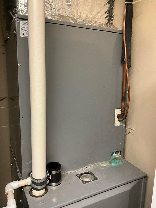 Completed estimate for replacement of 23-year-old 5-ton air conditioning system. Evaluated existing indoor air handler unit and ductwork configuration in utility space. Customer expressed interest in upgrading to Trane equipment and considering heat pump option for increased energy efficiency and year-round comfort. Documented current system setup including air handler, ductwork assembly, refrigerant lines, condensate drainage, and electrical connections to provide accurate replacement specifications and equipment recommendations.