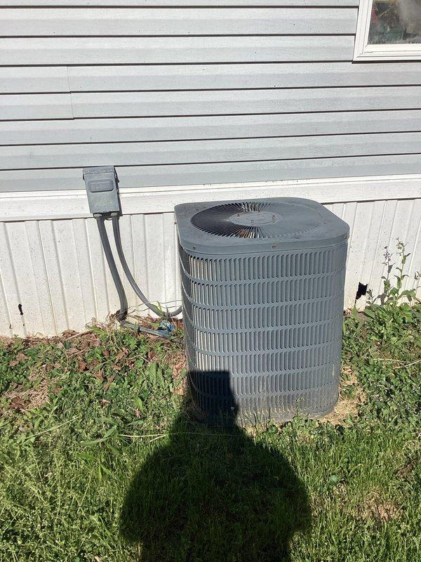 Responded to service call for air conditioning system running but not cooling adequately. Performed system inspection of outdoor condenser unit and indoor air handler with filter access. Documented equipment condition with photos showing condenser unit positioned on concrete pad with electrical disconnect, and indoor air handler cabinet with dual filter configuration and digital display panel. Provided estimate for duct cleaning services as requested.