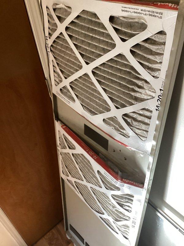 Responded to service call for air conditioning system running but not cooling adequately. Performed system inspection of outdoor condenser unit and indoor air handler with filter access. Documented equipment condition with photos showing condenser unit positioned on concrete pad with electrical disconnect, and indoor air handler cabinet with dual filter configuration and digital display panel. Provided estimate for duct cleaning services as requested.