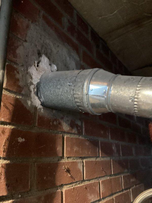 Responded to service call regarding moisture infiltration and condensation issues affecting interior brick chimney chase, with visible drywall damage and paint deterioration on adjacent walls. Performed comprehensive inspection of existing ceramic flue system serving both gas furnace and water heater venting through central brick chimney. Upon examination, identified compromised flue liners allowing combustion gases and moisture to penetrate into brick chase cavity, causing condensation accumulation and structural concerns. Documented existing metallic ductwork configuration and flue penetrations through masonry with photographic evidence. Assessed venting requirements for both appliances and evaluated chimney chase condition to determine appropriate remediation approach. Provided technical recommendations for flue replacement options, including metal liner systems suitable for dual-appliance venting applications, and outlined scope of work necessary to address moisture intrusion and r