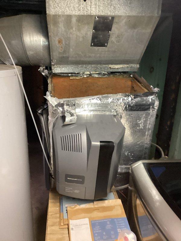 Responded to service call for disconnected heating vent and fallen ductwork in residential HVAC system. Upon inspection, found heating vent had completely separated from main house venting system, requiring immediate reconnection to restore proper airflow and system functionality. Secured all ductwork connections, verified proper alignment of metallic ductwork with reflective insulation wrapping, and ensured Honeywell humidifier unit and associated plenum remained properly integrated within the system. Confirmed all flexible conduit connections were secure and tested system operation to verify restored airflow throughout the residence.