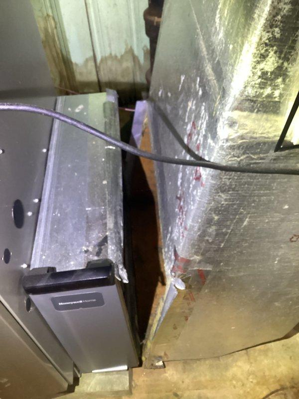 Responded to service call for disconnected heating vent and fallen ductwork in residential HVAC system. Upon inspection, found heating vent had completely separated from main house venting system, requiring immediate reconnection to restore proper airflow and system functionality. Secured all ductwork connections, verified proper alignment of metallic ductwork with reflective insulation wrapping, and ensured Honeywell humidifier unit and associated plenum remained properly integrated within the system. Confirmed all flexible conduit connections were secure and tested system operation to verify restored airflow throughout the residence.