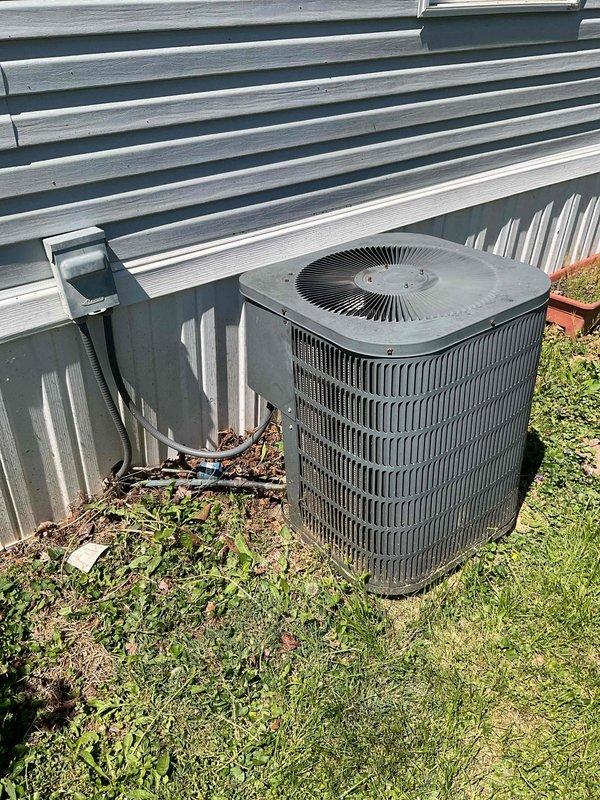 Comfort consultant conducted on-site evaluation of 30-year-old HVAC system experiencing complete refrigerant loss. Assessed outdoor condenser unit condition, noting significant debris accumulation at base and around unit, along with deteriorated electrical wiring requiring replacement. Provided comprehensive replacement options for full system upgrade and duct cleaning services to address aging equipment and multiple component failures.