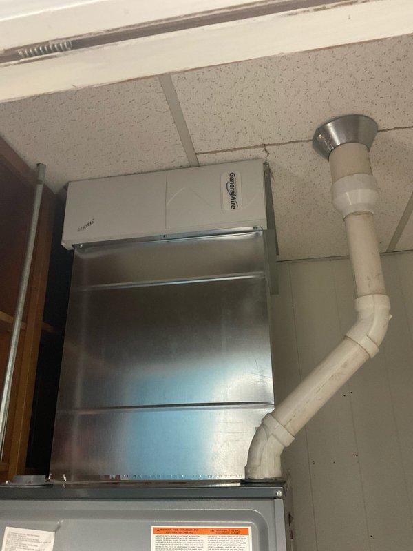 Conducted on-site assessment for duct cleaning estimate and evaluated feasibility of relocating register and associated ductwork from existing room. Documented current HVAC system configuration including ceiling-mounted equipment, ductwork layout, and condensate drainage system, as well as existing floor register location in office space with baseboard heating supplementation.