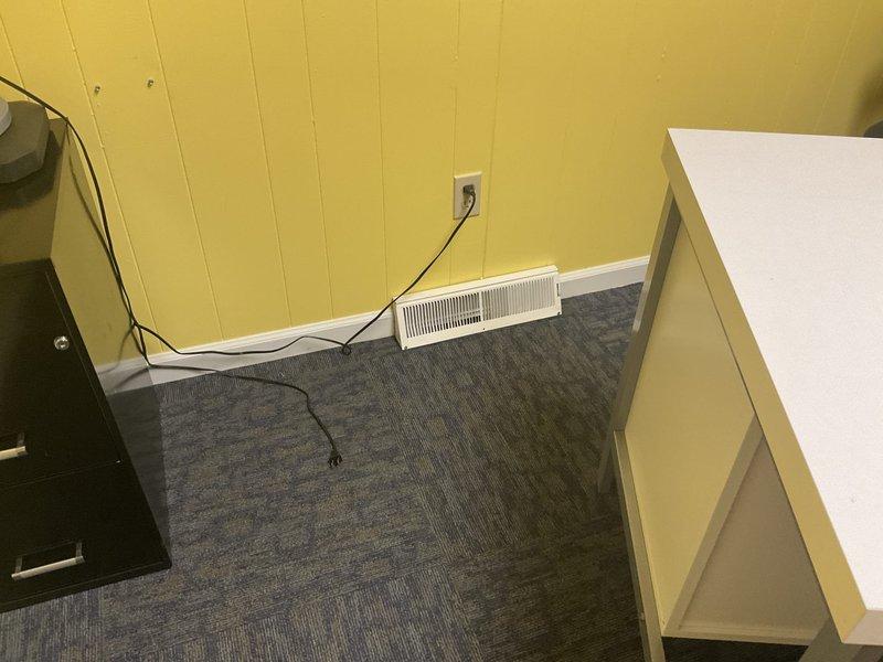 Conducted on-site assessment for duct cleaning estimate and evaluated feasibility of relocating register and associated ductwork from existing room. Documented current HVAC system configuration including ceiling-mounted equipment, ductwork layout, and condensate drainage system, as well as existing floor register location in office space with baseboard heating supplementation.