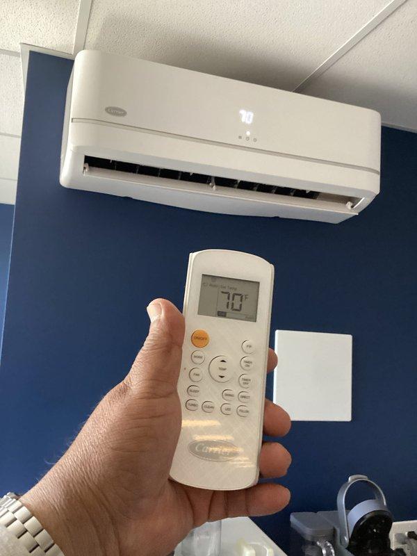 Responded to service call for leaking ductless mini-split system in commercial break room. Upon inspection, identified active water leak from wall-mounted Carrier air handler unit. Diagnosed condensate drainage issue causing water to escape from indoor unit rather than properly draining through condensate line.