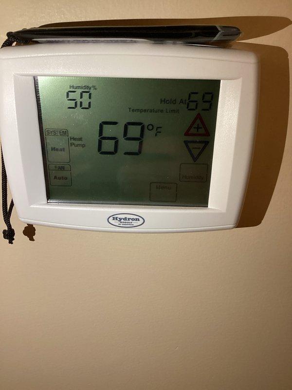 Completed comprehensive cooling maintenance service including coil cleaning, general component inspection, and system performance evaluation. Verified thermostat operation with Hydron unit displaying proper temperature control at 68°F hold setting with heat pump configuration. Standard 16x25x4 filter replacement not included per service agreement specifications.