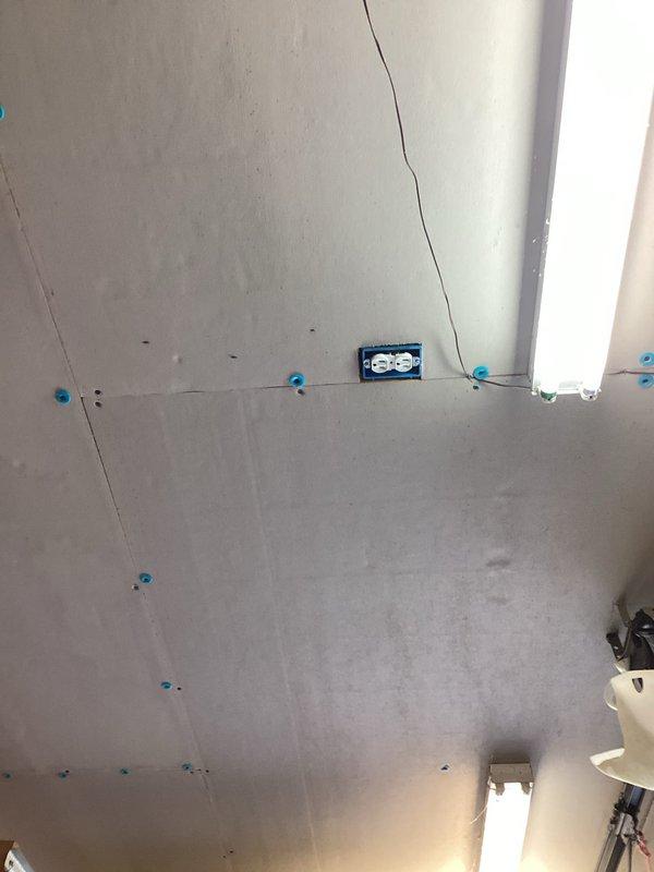 Installed dedicated electrical circuits for a ceiling fan and air compressor in an unfinished space. Ran new wiring from the main electrical panel to the designated locations, mounting a blue outlet box at the ceiling/wall junction for the air compressor circuit. Added appropriate circuit breakers to the panel and made all necessary connections to the bus bars using proper gauge conductors. Installed mounting hardware and electrical box for the ceiling fan location. All work completed to code specifications with secure wire terminations and proper circuit protection.