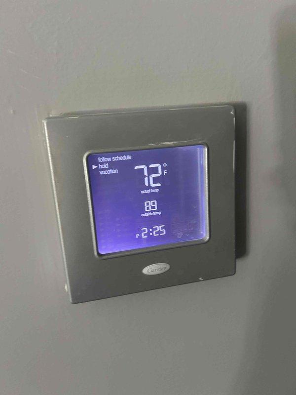 Completed basic monthly cooling maintenance visit on Carrier air conditioning system. Inspected outdoor condenser unit and verified operational status, checked thermostat programming and settings showing 72°F setpoint with system in scheduled mode. Customer requested water heater draining service for future scheduling; noted that 16x25x4 filter is not included in basic monthly service plan.