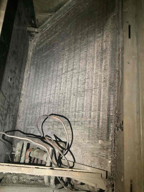 Responded to no-cooling complaint on commercial HVAC system with suspected fan motor failure. Upon inspection, accessed indoor unit and found evaporator coil with moderate dust accumulation and examined outdoor unit electrical compartment revealing disorganized wiring connections with visible wear and debris accumulation. Documented equipment condition showing signs of age and lack of maintenance, including dirty coil surfaces and loose electrical connections requiring attention to restore proper system operation.