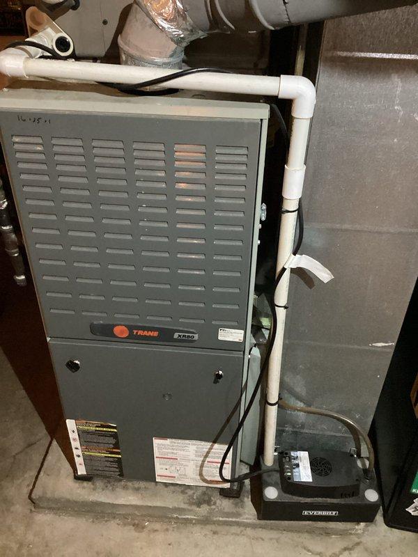 Responded to callback for burnt rubber odor during heating operation and air conditioning failure to start. Inspected Trane XR80 furnace system and verified thermostat operation set at 75°F. Conducted thorough examination of furnace cabinet, blower assembly, and electrical components to identify source of odor and AC malfunction. Documented equipment condition with photos showing proper installation and current system configuration for service records.