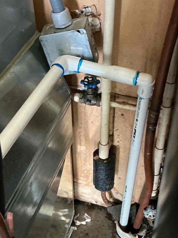Responded to water heater leak discovered during routine HVAC maintenance. Upon inspection, confirmed active leak from tanked water heater requiring immediate attention. Replaced failed water heater unit and installed new plumbing configuration including PVC supply lines with gate valves for isolation capability, proper condensate pan for leak protection, and black foam pipe insulation on vertical sections to prevent condensation and heat loss. Ensured all connections were secure with compression fittings and verified proper drainage. System tested and confirmed operational with no leaks detected.
