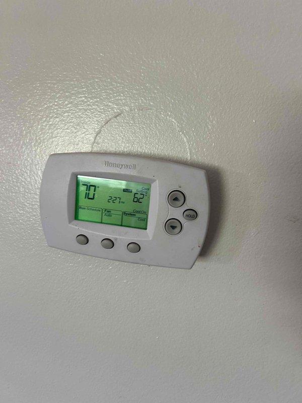 Completed basic monthly heating maintenance on residential HVAC system. Performed standard inspection of heating equipment, verified thermostat operation showing 70°F setpoint with proper display function, and inspected exterior electrical junction box with wiring connections secured with wire nuts. All components operating within normal parameters with no issues identified during routine preventative maintenance visit.