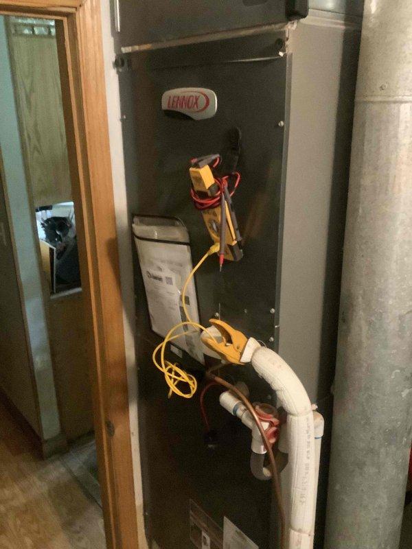 Completed scheduled cooling system maintenance on Lennox split system with outdoor condensing unit and indoor air handler. Performed comprehensive tune-up including visual inspection of both indoor and outdoor components, electrical testing with multimeter to verify proper voltage and amperage, checked refrigerant pressures and system operation. Inspected condensate drain line routing and verified proper drainage. All components operating within manufacturer specifications, system running efficiently with no issues identified.