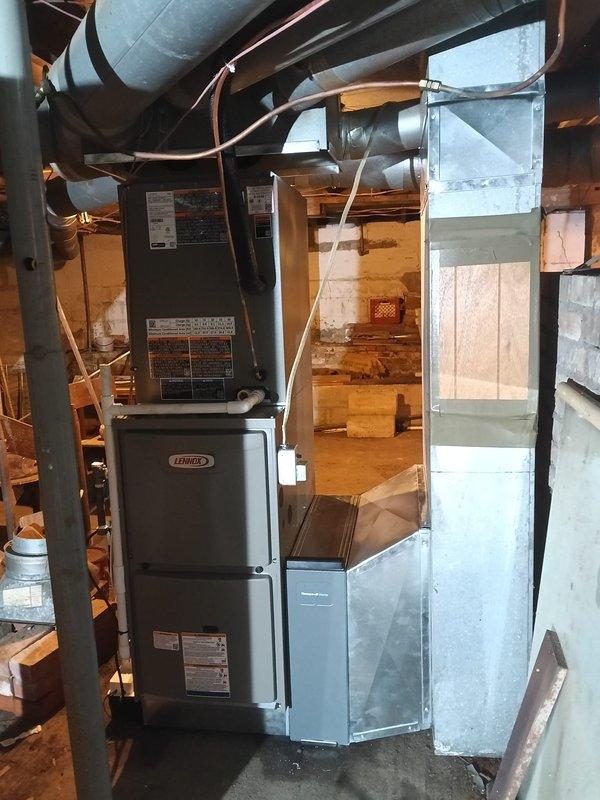 Completed full HVAC system installation featuring a Lennox gas furnace and air conditioning unit in basement mechanical room. Installation included comprehensive duct modification work with new insulated supply ductwork, galvanized metal plenum fabrication, and integration of humidification system at furnace base. Modified existing ductwork routing to accommodate new equipment configuration, ensuring proper airflow distribution throughout the residence. All refrigerant lines, electrical connections, and control wiring installed to manufacturer specifications. System tested and verified operational upon completion.