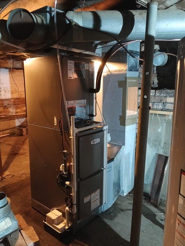Completed full HVAC system installation featuring a Lennox gas furnace and air conditioning unit in basement mechanical room. Installation included comprehensive duct modification work with new insulated supply ductwork, galvanized metal plenum fabrication, and integration of humidification system at furnace base. Modified existing ductwork routing to accommodate new equipment configuration, ensuring proper airflow distribution throughout the residence. All refrigerant lines, electrical connections, and control wiring installed to manufacturer specifications. System tested and verified operational upon completion.
