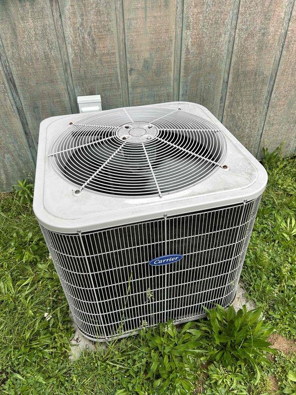 Completed basic monthly cooling maintenance on Carrier split system. Inspected outdoor condenser unit, verified fan operation and coil condition. Inspected indoor air handler unit in utility space, noted evidence of moisture accumulation on equipment surfaces and surrounding concrete floor indicating potential condensate drainage concerns that will require monitoring.