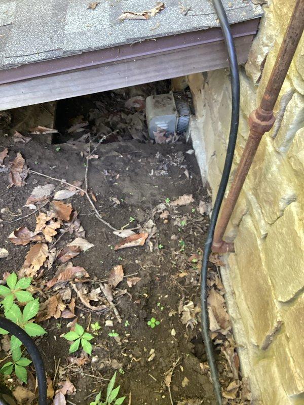 Responded to emergency water softener leak where system discharged water into surrounding area. Inspected installation location, documented compromised exterior conditions including exposed insulation and debris accumulation near unit, and assessed plumbing connections including water supply lines, gas line, and PVC drainage system to identify source of system failure and prevent further water damage.