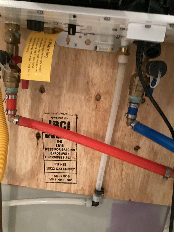 Responded to emergency water softener leak where system discharged water into surrounding area. Inspected installation location, documented compromised exterior conditions including exposed insulation and debris accumulation near unit, and assessed plumbing connections including water supply lines, gas line, and PVC drainage system to identify source of system failure and prevent further water damage.