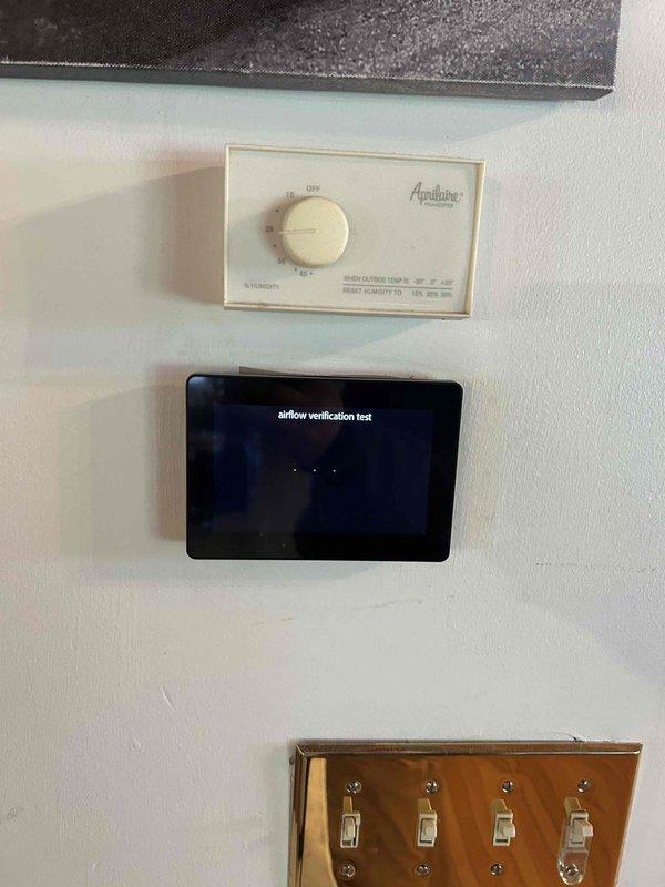 Returned to property to address severe evaporator coil freeze-up condition with extensive ice buildup throughout the coil assembly. Replaced malfunctioning thermostat with new Aprilaire unit and installed airflow verification device to monitor system performance. Inspected living room ductwork as requested and addressed any fallen sections to restore proper airflow distribution throughout the system.