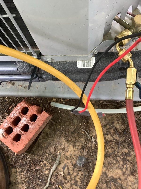 Performed cooling maintenance on 2.5-ton Carrier air conditioning system recently installed by another company. Connected manifold gauges to service ports and verified refrigerant pressures and system operation. Replaced 16x20x1 air filter and documented unit condition with photos showing outdoor condenser unit with significant debris accumulation around base requiring future cleaning attention.