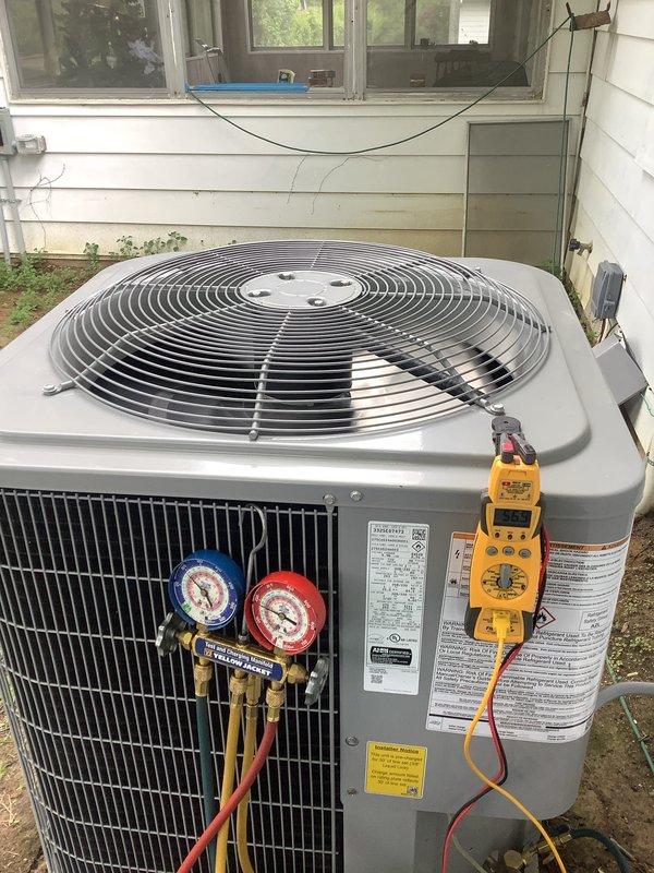 Performed cooling maintenance on 2.5-ton Carrier air conditioning system recently installed by another company. Connected manifold gauges to service ports and verified refrigerant pressures and system operation. Replaced 16x20x1 air filter and documented unit condition with photos showing outdoor condenser unit with significant debris accumulation around base requiring future cleaning attention.