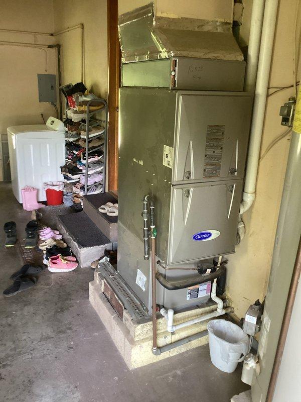 Responded to service call to diagnose issue with Carrier furnace system. Performed comprehensive inspection of indoor furnace unit located in basement and outdoor condenser unit. Evaluated system components including ductwork connections, copper refrigerant lines, electrical connections, and condensate drainage. Inspected outdoor condenser unit for proper operation, assessed condition of coils and fan assembly, and verified refrigerant line integrity between indoor and outdoor components. System evaluation completed and findings documented with photographic evidence for customer records.
