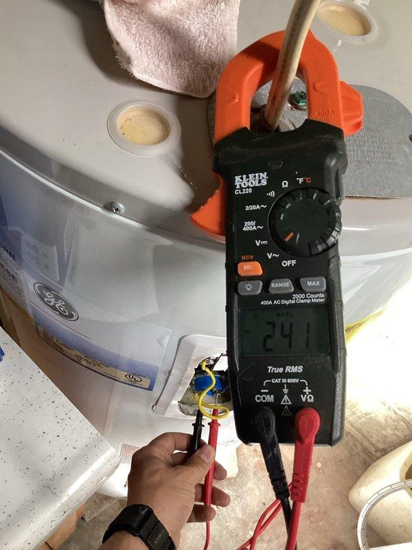 Responded to service call for non-functional GE tanked electric water heater at residential property. Upon arrival, performed diagnostic evaluation of unit including visual inspection of tank condition, electrical connections, and plumbing connections. Utilized Klein Tools CL220 digital clamp meter to test electrical current draw and verify power supply to heating elements, recording amperage reading of 24.1 amps. Inspected both upper and lower element access panels, circuit breakers, and wiring connections for signs of failure or damage. Assessed copper supply lines with insulation sleeves, drain valve operation, and overall tank integrity. Documented equipment condition through photographic evidence showing electrical testing procedures and overall unit configuration. Provided comprehensive assessment of water heater functionality and presented homeowner with repair options versus full system replacement recommendations based on diagnostic findings.