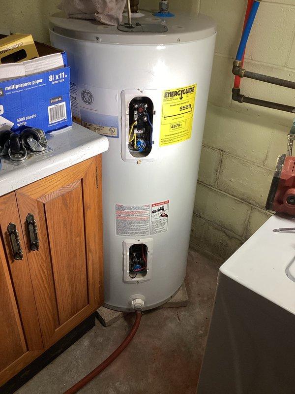 Responded to service call for non-functional GE tanked electric water heater at residential property. Upon arrival, performed diagnostic evaluation of unit including visual inspection of tank condition, electrical connections, and plumbing connections. Utilized Klein Tools CL220 digital clamp meter to test electrical current draw and verify power supply to heating elements, recording amperage reading of 24.1 amps. Inspected both upper and lower element access panels, circuit breakers, and wiring connections for signs of failure or damage. Assessed copper supply lines with insulation sleeves, drain valve operation, and overall tank integrity. Documented equipment condition through photographic evidence showing electrical testing procedures and overall unit configuration. Provided comprehensive assessment of water heater functionality and presented homeowner with repair options versus full system replacement recommendations based on diagnostic findings.