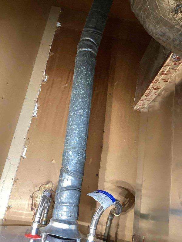 Returned to property to complete replacement of 40-gallon short propane water heater. Removed existing unit and installed new propane-fired water heater in corner location. Connected copper supply lines to top of tank using appropriate fittings and made all necessary gas line connections to control valve assembly. Installed required PVC venting with proper pitch and secured all connections. Verified proper operation of gas valve, pilot light ignition, and temperature controls. Tested all plumbing connections for leaks and confirmed unit is heating properly. Installation completed per manufacturer specifications and local plumbing codes.