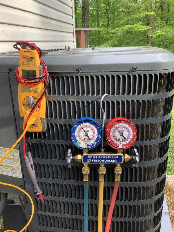 Responded to no cooling complaint on residential air conditioning system. Upon arrival, connected Yellow Jacket manifold gauge set and digital multimeter to outdoor condensing unit to diagnose system performance. Performed refrigerant pressure testing and electrical diagnostics to identify cause of cooling failure. System evaluated and measurements documented for proper cooling restoration.