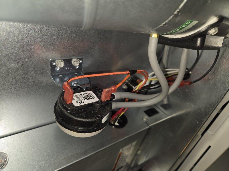 Returned to site and replaced defective pressure switch under warranty. Installed new pressure switch assembly, connected electrical terminals with proper wiring, and verified secure mounting within furnace cabinet. System tested and confirmed proper operation of safety controls.