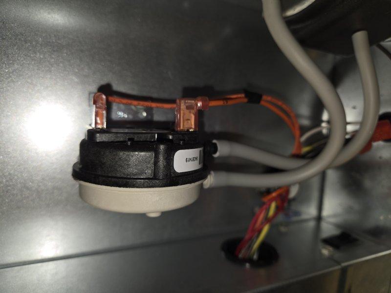 Returned to site and replaced defective pressure switch under warranty. Installed new pressure switch assembly, connected electrical terminals with proper wiring, and verified secure mounting within furnace cabinet. System tested and confirmed proper operation of safety controls.