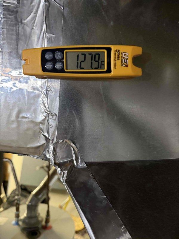 Completed full installation of Lennox air conditioning and gas furnace system. Installed new indoor furnace unit and outdoor AC condenser, connected refrigerant lines, and integrated ductwork with proper insulation and sealing. Configured new digital thermostat on interior wall for system control, verified all electrical connections, and tested system operation with supply air temperature reading of 127.9°F at the plenum, confirming proper heating functionality.