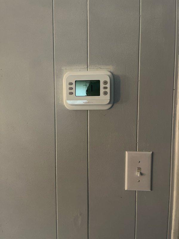 Completed full installation of Lennox air conditioning and gas furnace system. Installed new indoor furnace unit and outdoor AC condenser, connected refrigerant lines, and integrated ductwork with proper insulation and sealing. Configured new digital thermostat on interior wall for system control, verified all electrical connections, and tested system operation with supply air temperature reading of 127.9°F at the plenum, confirming proper heating functionality.