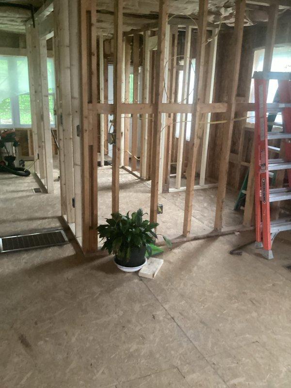 Conducted on-site plumbing estimate for residential remodel project with extensive interior renovation in progress. Assessed framing layout across multiple rooms to determine piping routing requirements for new plumbing installations. Evaluated existing concrete subfloor conditions and identified locations for floor penetrations to accommodate supply and drain lines. Documented exposed stud wall configurations to plan optimal pipe placement within wall cavities before drywall installation. Reviewed HVAC floor register locations to ensure plumbing infrastructure coordination and avoid conflicts with existing mechanical systems.
