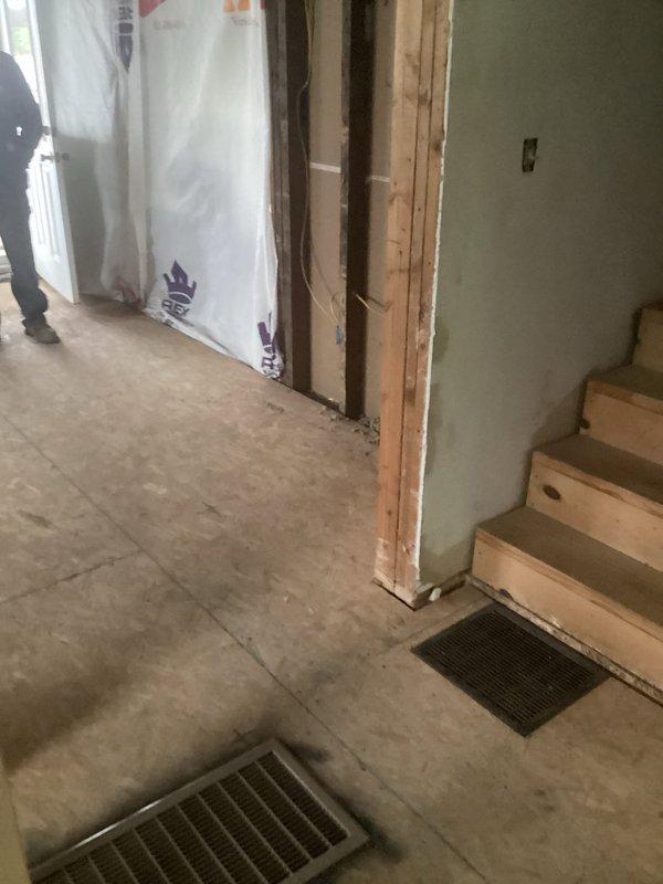 Conducted on-site plumbing estimate for residential remodel project with extensive interior renovation in progress. Assessed framing layout across multiple rooms to determine piping routing requirements for new plumbing installations. Evaluated existing concrete subfloor conditions and identified locations for floor penetrations to accommodate supply and drain lines. Documented exposed stud wall configurations to plan optimal pipe placement within wall cavities before drywall installation. Reviewed HVAC floor register locations to ensure plumbing infrastructure coordination and avoid conflicts with existing mechanical systems.