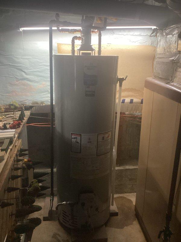 Replaced existing 40-gallon natural gas water heater with new Bradford White 40-gallon residential unit rated at 40,000 BTU/hr input. Installed unit in basement utility area, connected copper supply and outlet piping, verified proper gas line connections and pressure settings per manufacturer specifications, and tested unit operation to ensure proper heating function and safety compliance.