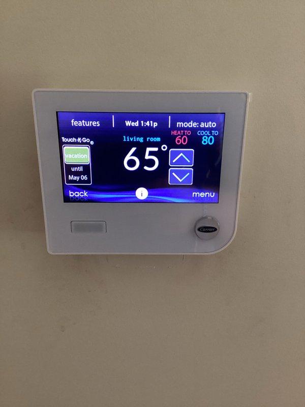 Completed basic monthly cooling maintenance visit on residential HVAC system. Inspected Carrier outdoor condensing unit and verified thermostat operation showing proper temperature control set to auto mode with cooling setpoint at 80°F and heating at 60°F. Performed routine system inspection, confirmed unit operational status, and documented equipment condition through photographic records of both indoor controls and outdoor equipment.