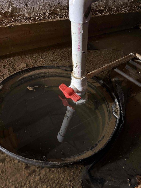 Responded to crawl space flooding issue and successfully pumped out standing water using trash pump. Removed failed sump pump assembly and installed new sump pump unit with PVC discharge piping and check valve in basin to prevent future water accumulation. Verified proper pump operation and drainage functionality upon completion.