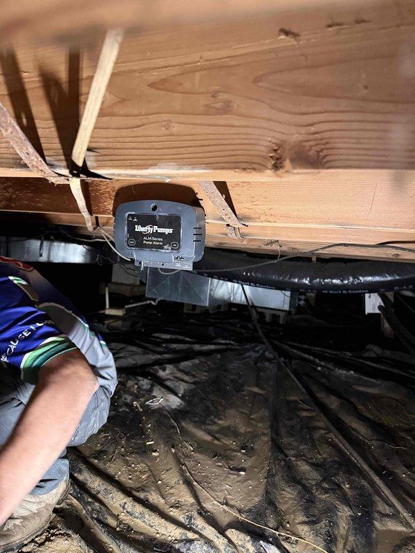 Responded to crawl space flooding issue and successfully pumped out standing water using trash pump. Removed failed sump pump assembly and installed new sump pump unit with PVC discharge piping and check valve in basin to prevent future water accumulation. Verified proper pump operation and drainage functionality upon completion.